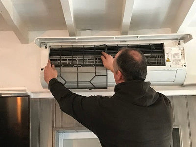 installer fixing Panasonic nanoeTM X abover door way