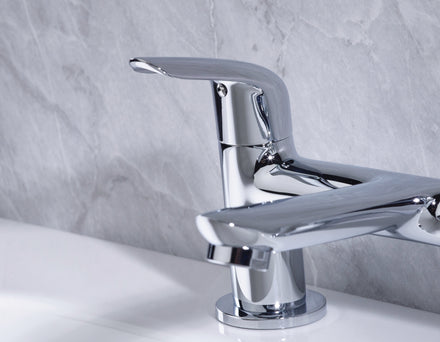 Bristan Aster Bath Filler Chrome tap on a white bath with a gray marble wall background