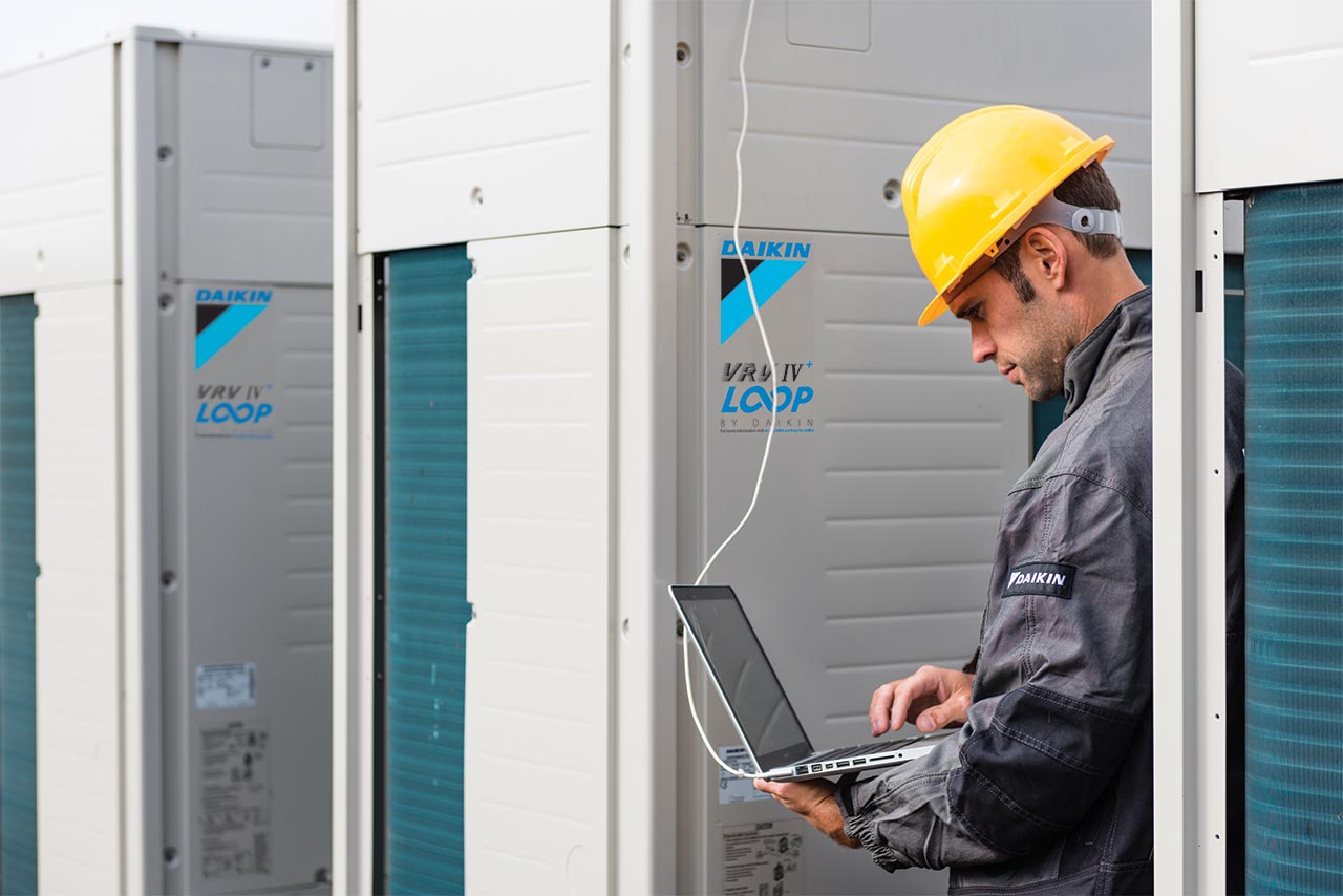 Daikin VRV IV+ - RYYQ-U units with install looking at laptop