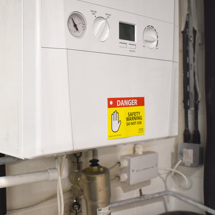 Arctic Hayes Danger Safety Warning Tags on a boiler