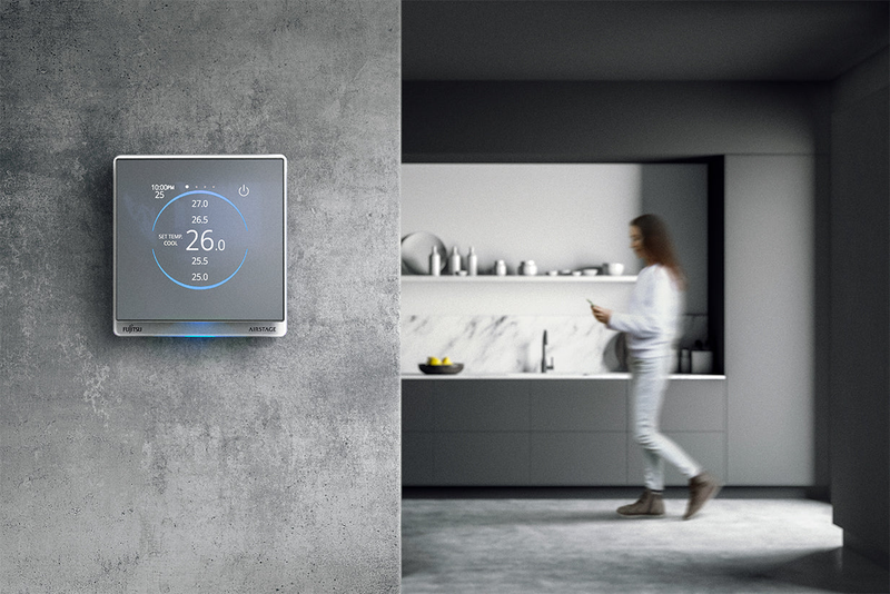 Fujitsu thermostat on grey stone wall with grey modern kitchen in background